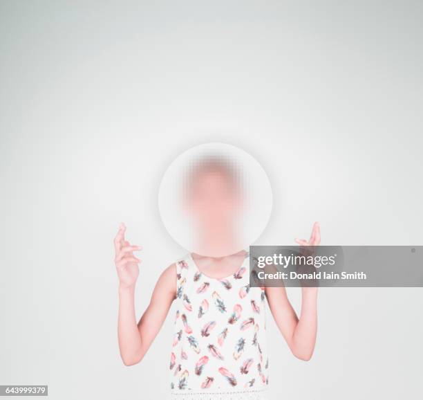 mixed race girl with face obscured by sphere - pixelated face stock pictures, royalty-free photos & images