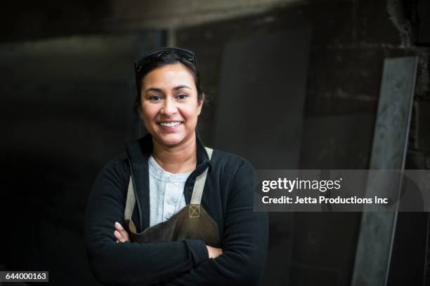 mixed race worker smiling in factory - industrial portraits character photos et images de collection