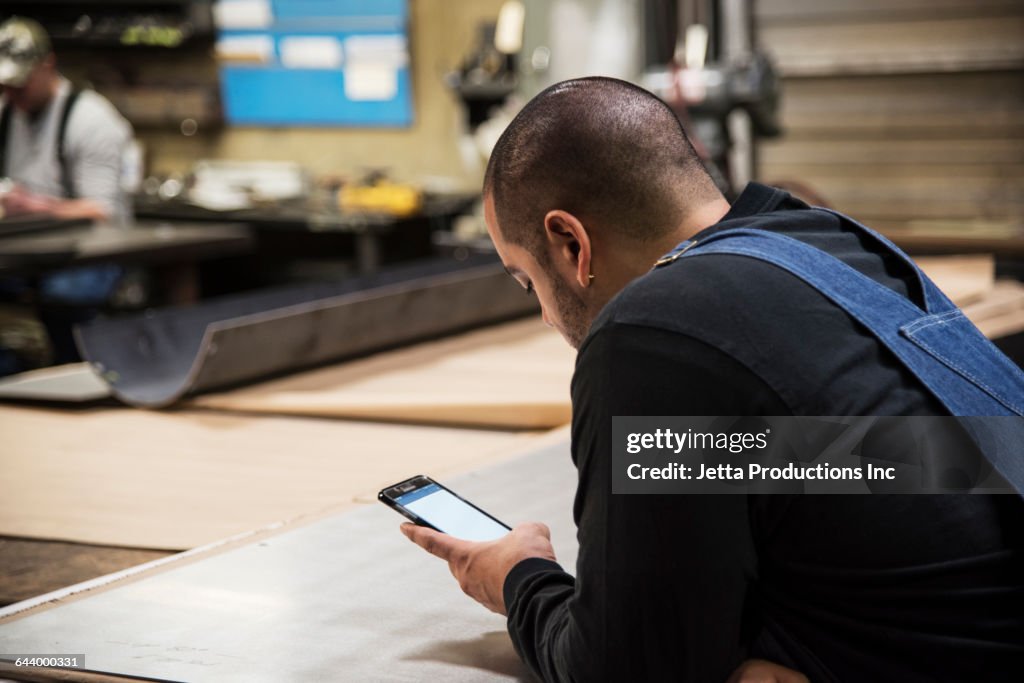 Worker Using Smartphone Worker Using Cell Phone In Factory High-Res Stock Photo - Getty Images