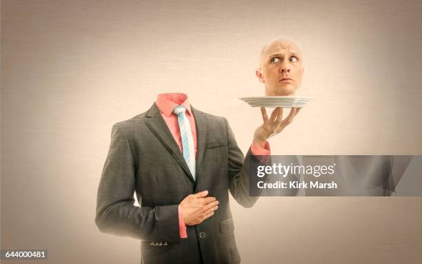 caucasian man holding his head on platter - decapitado imagens e fotografias de stock