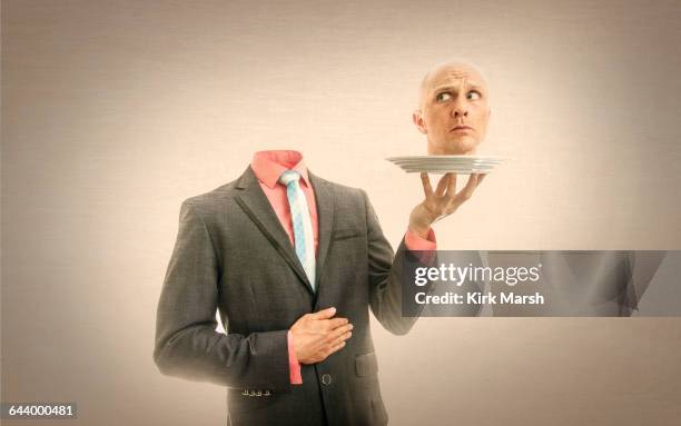 caucasian man holding his head on platter - headless man 個照片及圖片檔