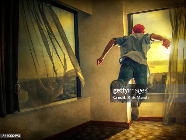 caucasian man flying through window - people in air stock pictures, royalty-free photos & images