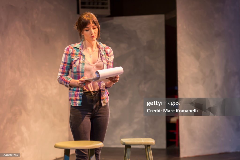 Hispanic actress rehearsing on theater stage