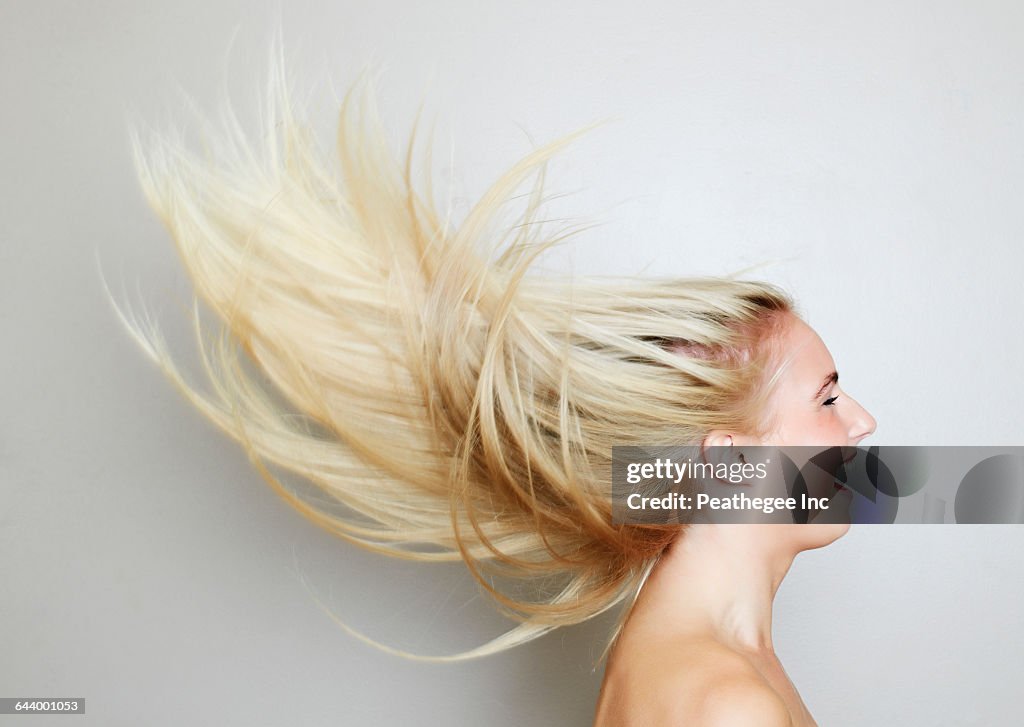 Blonde hair of Caucasian woman blowing in wind