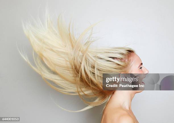 blonde hair of caucasian woman blowing in wind - long blonde hair stock pictures, royalty-free photos & images