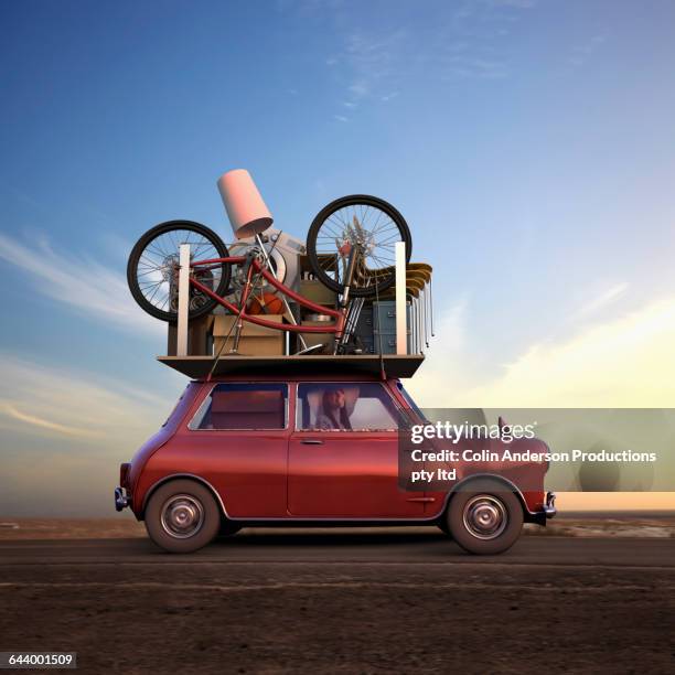 pacific islander woman hauling possessions on car - good move concept stockfoto's en -beelden