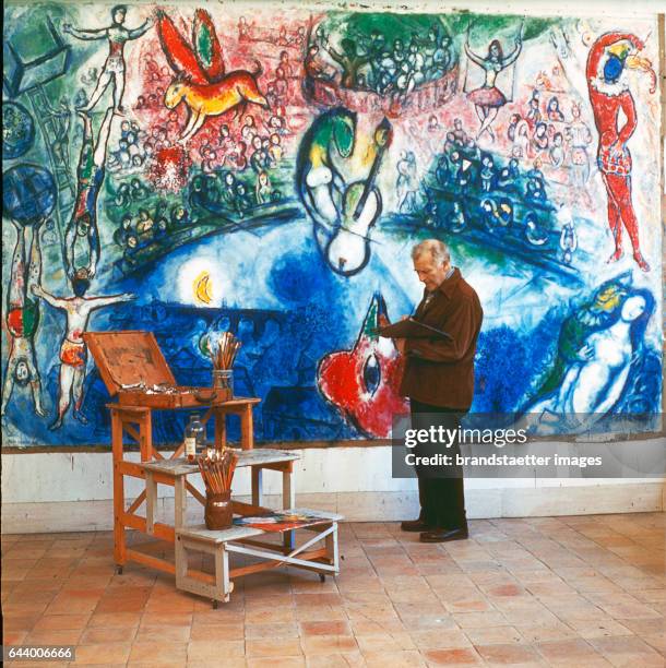 Painter Marc Chagall and his painting >Commedia dell`Arte< Photograph. 1959.