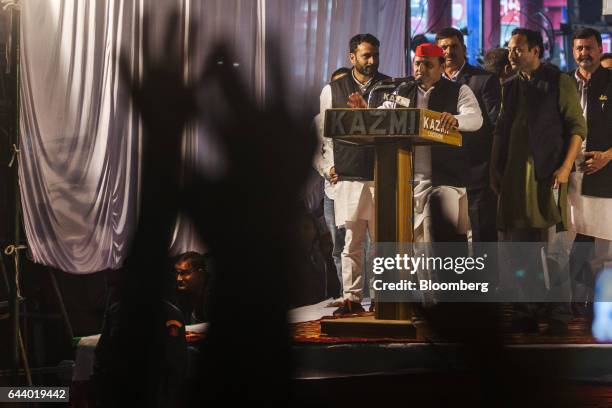 Akhilesh Yadav, chief minister of the state of Uttar Pradesh and president of the Samajwadi Party , center, speaks from a podium during a state...