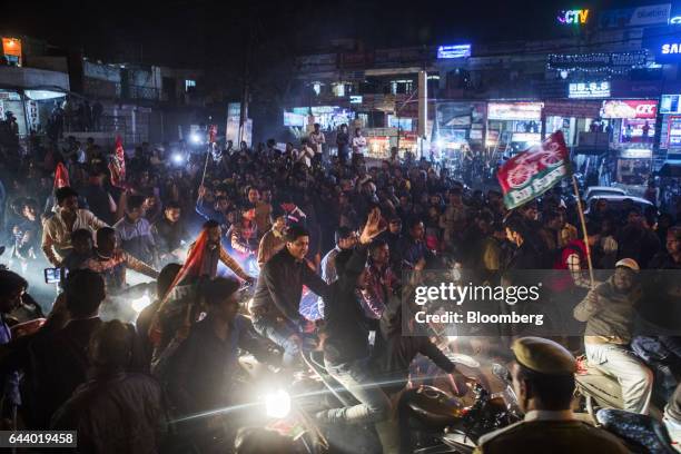 Supporters of the Samajwadi Party and Indian National Congress party ride motorcycles during a state election rally at night in Lucknow, Uttar...