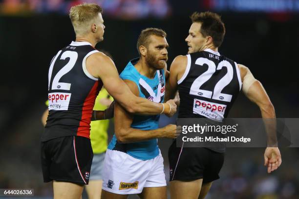 Nathan Krakouer of the Power is roughed up by Nick Riewoldt of the Saints and Nathan Brown after he was reported for an incident with Sean Dempster...