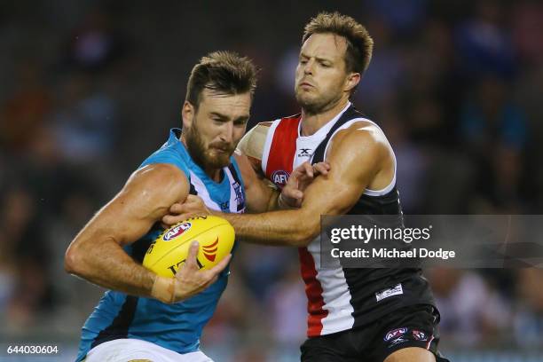 Charlie Dixon of the Power is tackled by Nathan Brown of the Saints during the JLT Community Series AFL match between the St Kilda Saints and the...