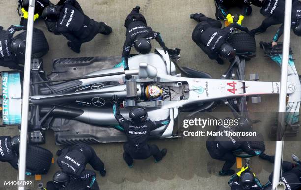 Lewis Hamilton of Great Britain and Mercedes GP returns to the garage for a tyre-change during the launch of the Mercedes formula one team's 2017...