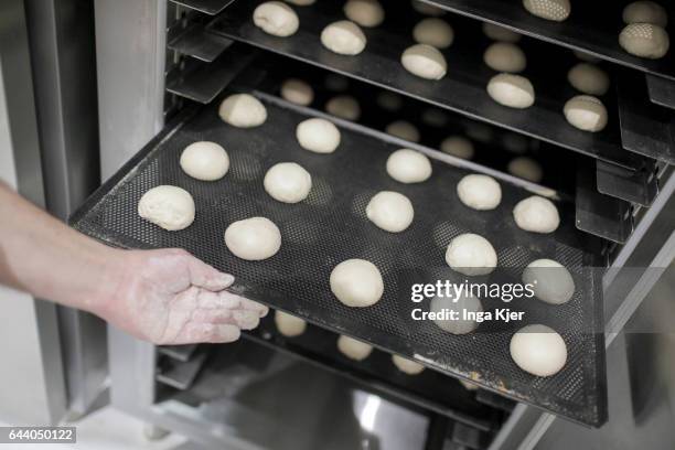 Berlin, Germany A baker pushes a baking tray with dough pieces into a stove on February 06, 2017 in Berlin, Germany.