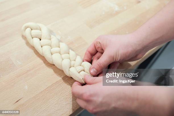 Berlin, Germany A yeast plait is braided on February 06, 2017 in Berlin, Germany.