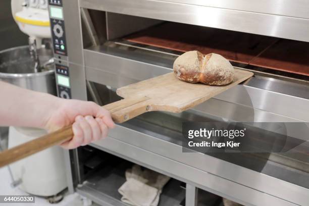 Berlin, Germany A baker takes a freshly baked bread from the oven on February 06, 2017 in Berlin, Germany.