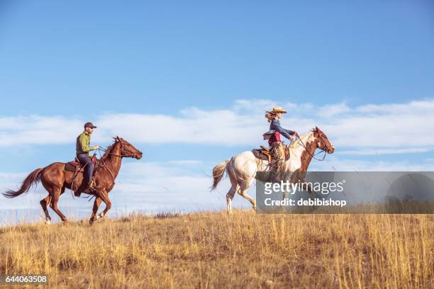 two people riding horseback - montana western usa stock pictures, royalty-free photos & images
