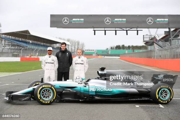 Lewis Hamilton of Great Britain and Mercedes GP, Mercedes GP Executive Director Toto Wolff and Valtteri Bottas of Finland and Mercedes GP pose during...