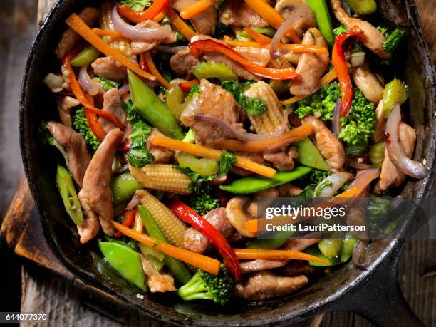 pork and vegetable stir fry - stir fried stock pictures, royalty-free photos & images