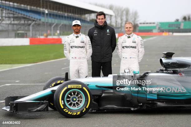 Lewis Hamilton of Great Britain and Mercedes GP, Mercedes GP Executive Director Toto Wolff and Valtteri Bottas of Finland and Mercedes GP pose during...