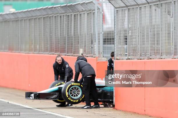 Members of the Mercedes GP wheel the car out for the launch of the Mercedes formula one team's 2017 car, the W08, at Silverstone Circuit on February...