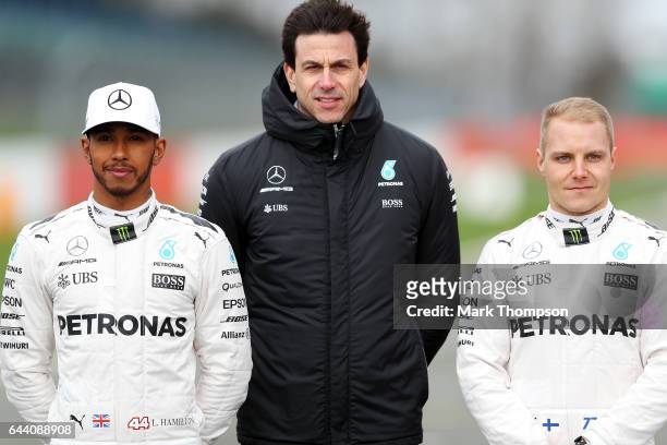 Lewis Hamilton of Great Britain and Mercedes GP, Mercedes GP Executive Director Toto Wolff and Valtteri Bottas of Finland and Mercedes GP pose during...