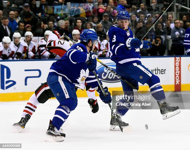 Jack Rodewald of the Binghamton Senators takes a hit from Rich Clune and Travis Dermott of the Toronto Marlies during AHL game action on February 20,...