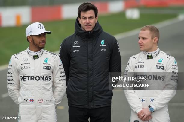 Mercedes AMG Petronas Formula One drivers Britain's Lewis Hamilton and Finland's Valtteri Bottas pose with Mercedes head Austria's Toto Wolff by the...