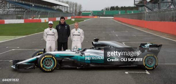 Mercedes AMG Petronas Formula One drivers Britain's Lewis Hamilton and Finland's Valtteri Bottas pose with Mercedes head Austria's Toto Wolff by the...