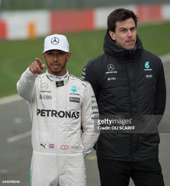 Mercedes AMG Petronas Formula One driver Britain's Lewis Hamilton and Mercedes team head Toto Wolff take part in the new Mercedes 2017 launch event...