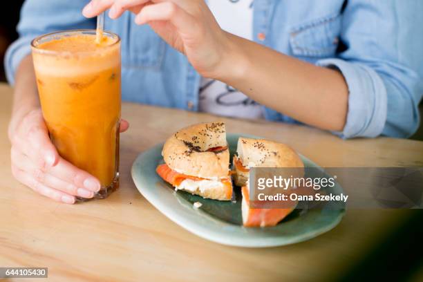 portrait of smiling woman with food - essen tisch stock pictures, royalty-free photos & images