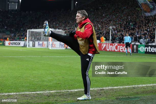 Bastian Schweinsteiger of Manchester United warms up during the UEFA Europa League Round of 32 second leg match between AS Saint-Etienne and...