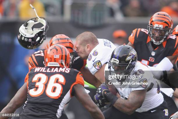 Terrance West runs the football upfield against Shawn Williams of the Cincinnati Bengals during their game at Paul Brown Stadium on January 1, 2017...