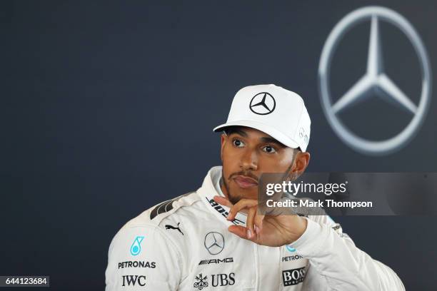 Lewis Hamilton of Great Britain and Mercedes GP looks on during a press conference at the launch of the Mercedes formula one team's 2017 car, the...