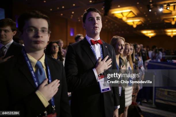 Attendants stand for the Pledge of Allegiance during the first day of the Conservative Political Action Conference at the Gaylord National Resort and...