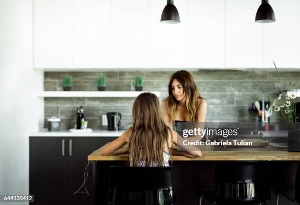 mother and daughter in their kitchen - cocina stock pictures, royalty-free photos & images