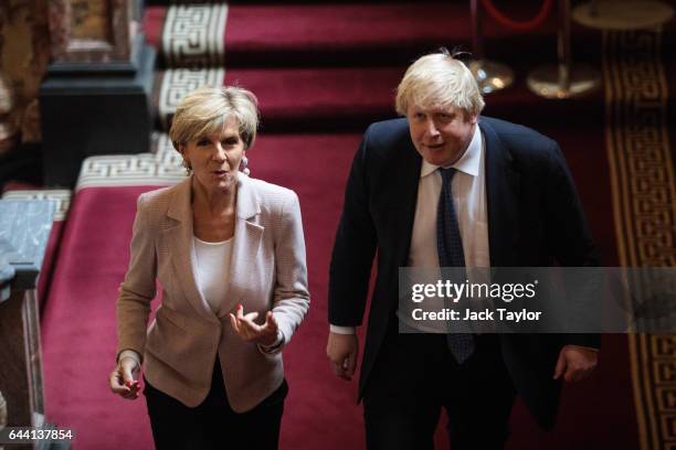 British Foreign Secretary Boris Johnson walks up the stairs with his Australian counterpart Foreign Minister Julie Bishop at the Foreign and...