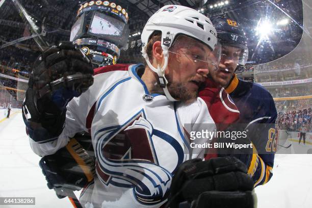 Marcus Foligno of the Buffalo Sabres checks John Mitchell of the Colorado Avalanche during an NHL game at the KeyBank Center on February 16, 2017 in...