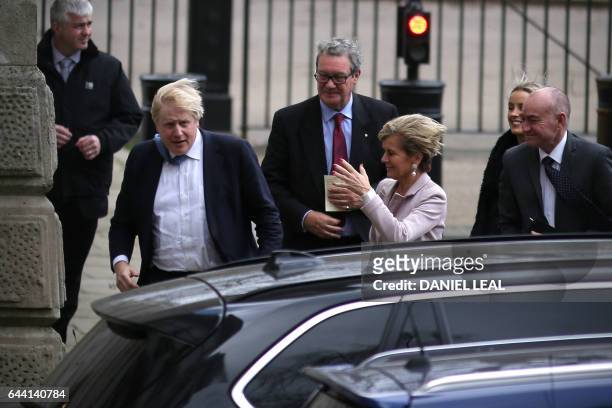 British Foreign minister Boris Johnson battles the wind after meeting his Australian counterpart Julie Bishop outside the Foreign and Commonwealth...