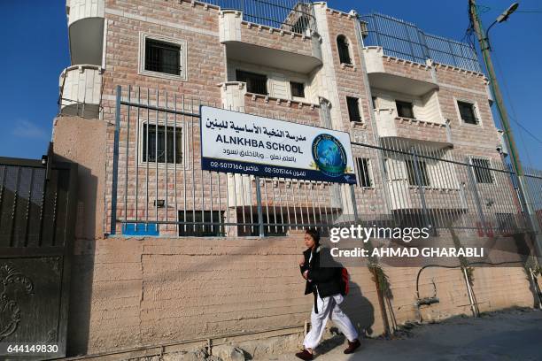 School girl walks past the Al-Nkhba School, a private Palestinian school in the Sur Baher district of Israeli-annexed east Jerusalem on February 23...