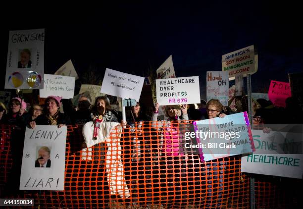 Protesters gather outside before Rep. Leonard Lance, R-N.J., holds a town hall meeting at the Raritan Valley Community College in Branchburg, N.J.,...