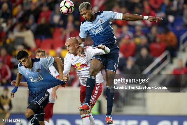 Kendall Waston of Vancouver Whitecaps heads clear while challenged by Aurelien Collin of New York Red Bulls during the New York Red Bulls Vs...