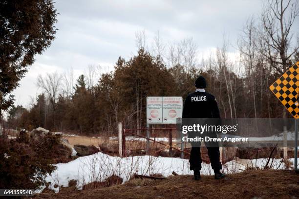 Royal Canadian Mounted Police officer stands at the U.S.-Canada, February 23, 2017 in Hemmingford, Quebec, Canada. In the past month, hundreds of...