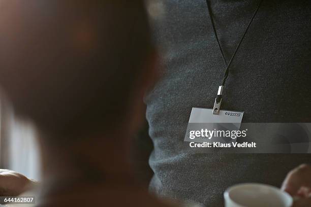 close-up of name tag of businessman at conference - correa accesorio personal fotografías e imágenes de stock