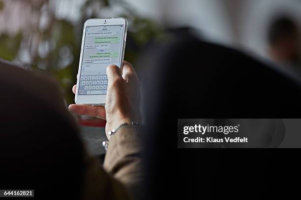 close-up of man texting with girl friend on phone - text stock pictures, royalty-free photos & images