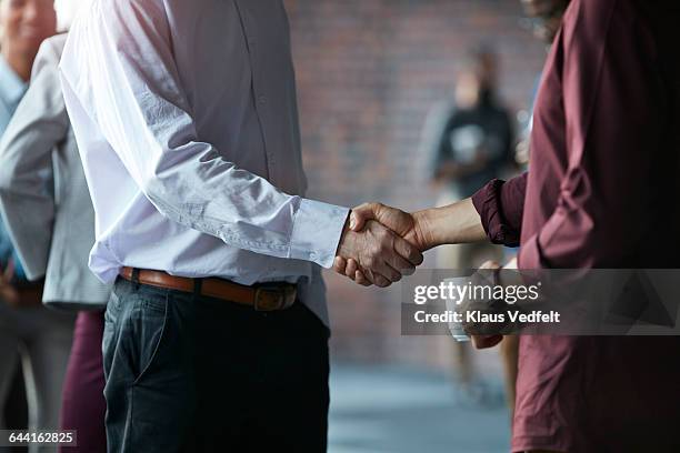 businessmen making handshake at conference - handshake closeup stock pictures, royalty-free photos & images