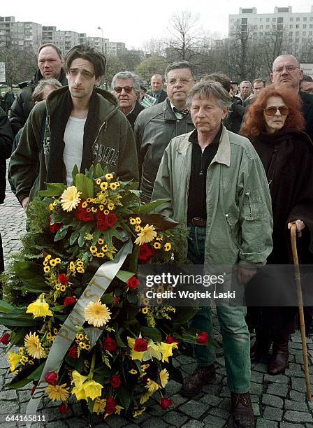 American actor Adrien Brody, Polish film producer Lew Rywin and Polish-French film director Roman Polanski lay flowers at the Monument to the Ghetto...