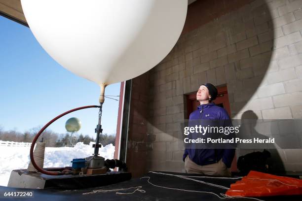 On the Job: Margaret Curtis, meteorologist for the National Weather Service, inflates a weather balloon with helium. Balloons are launched from NWS...