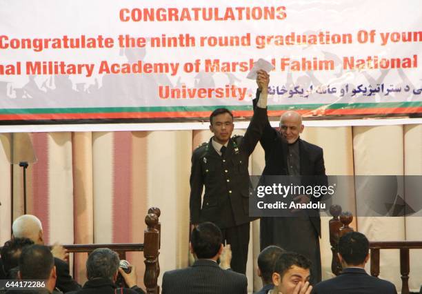 Afghan President Ashraf Ghani greets a military officer during the graduation ceremony of Afghan military officers at the National Military Academy...