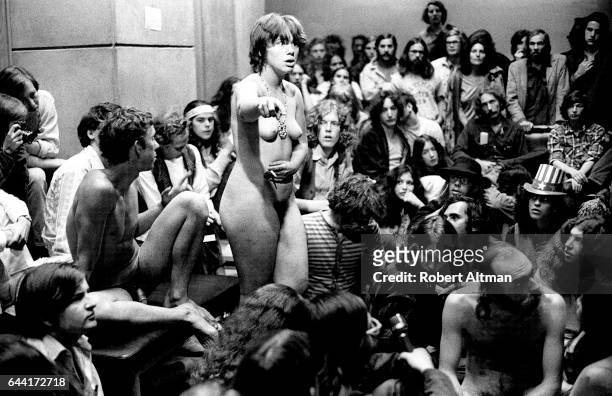 Man and woman sit and stand naked in front of a group of people during a meeting on the last day of The Alternative Media Conference on June 20, 1970...