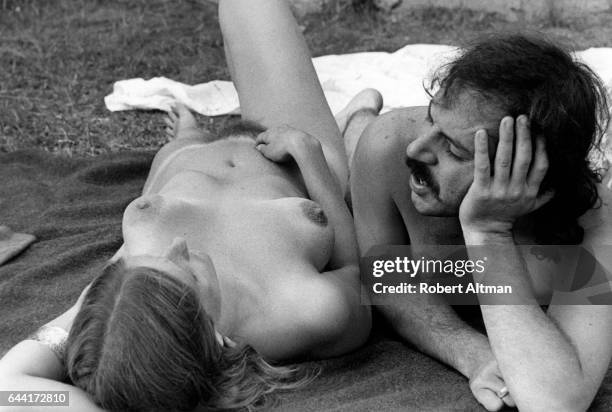 Photographer Robert Altman and Detroit Annie lay naked near a pond during The Alternative Media Conference on June 17-20, 1970 at Goddard College in...